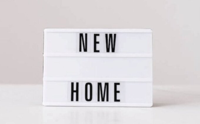 Rectangular light box emblazoned with the words NEW HOME.